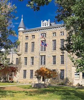 A large building with a clock tower and American flag. AI generated content