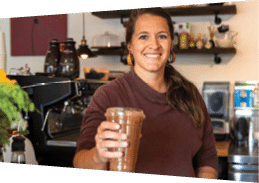 A woman in a brown shirt is holding a cup of coffee. AI generated content